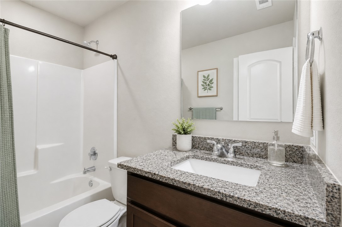 2725 Porter's Way Bryan, TX 77803 - Photo 16 of 19 a bathroom with a granite countertop sink and a mirror