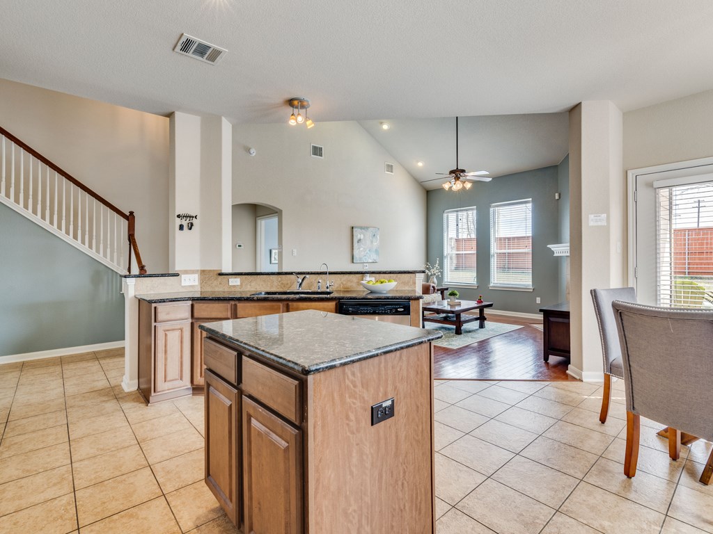 1131 Stone Rim Loop Buda, TX 78610 - Photo 1 of 1 Kitchen is open to living area with open bar - giving the space an airy feel.