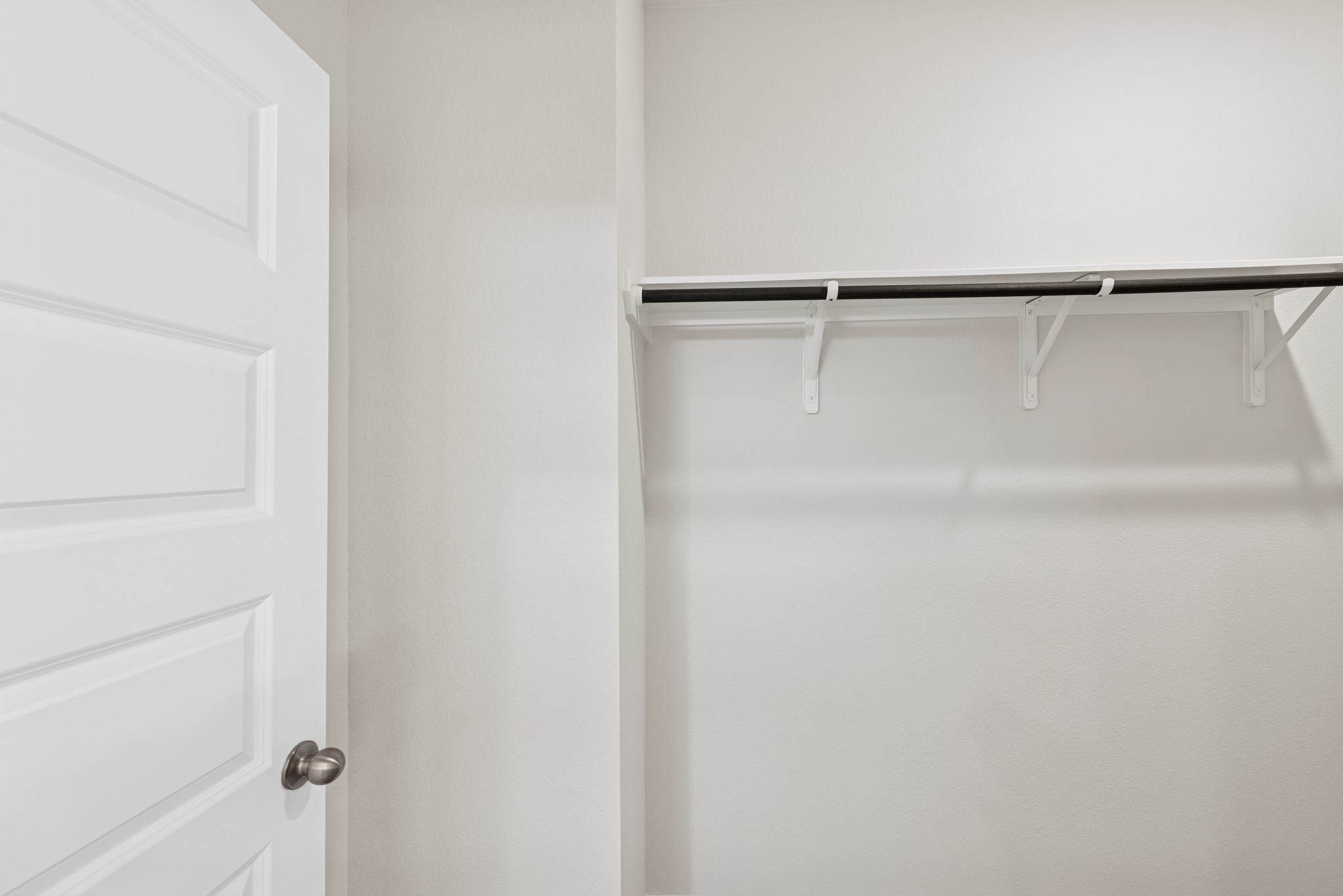 537 Stone Placa Trail Pattison, TX 77423 - Photo 18 of 28 a view of walk in closet with empty racks