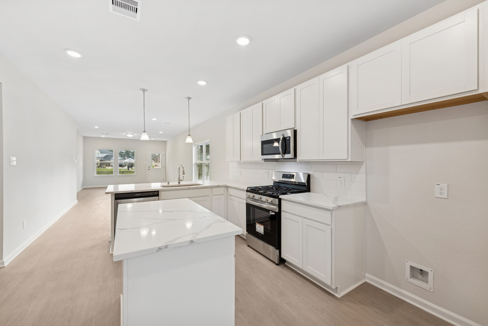 537 Stone Placa Trail Pattison, TX 77423 - Photo 2 of 28 a kitchen with white cabinets and stainless steel appliances
