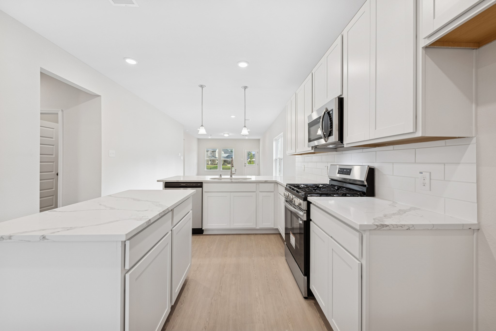 537 Stone Placa Trail Pattison, TX 77423 - Photo 3 of 28 a kitchen with granite countertop white cabinets and white appliances