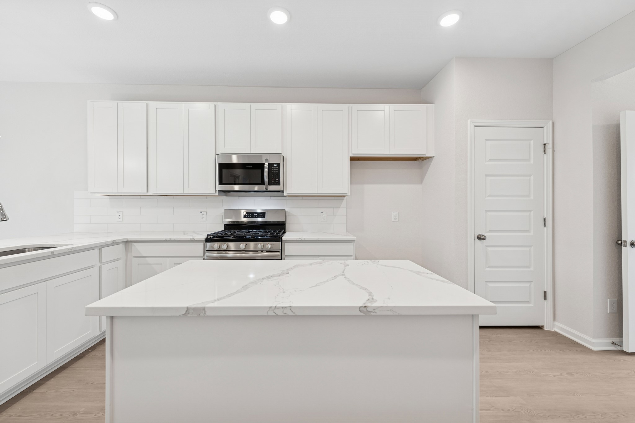 537 Stone Placa Trail Pattison, TX 77423 - Photo 4 of 28 a kitchen with a stove and a sink
