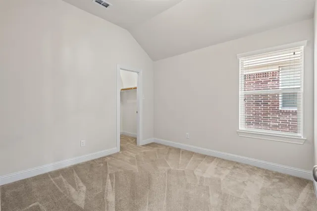 a view of a backyard with a garden and entertaining space