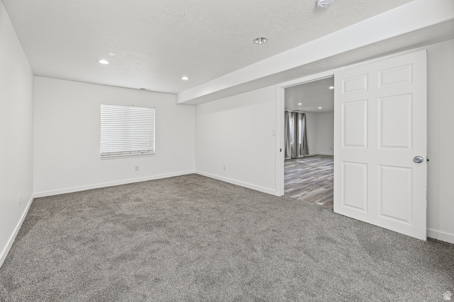 5525 Hampton Way Stansbury Park, UT 84074 - Photo 26 of 35 Spacious room with gray carpet flooring and recessed lighting