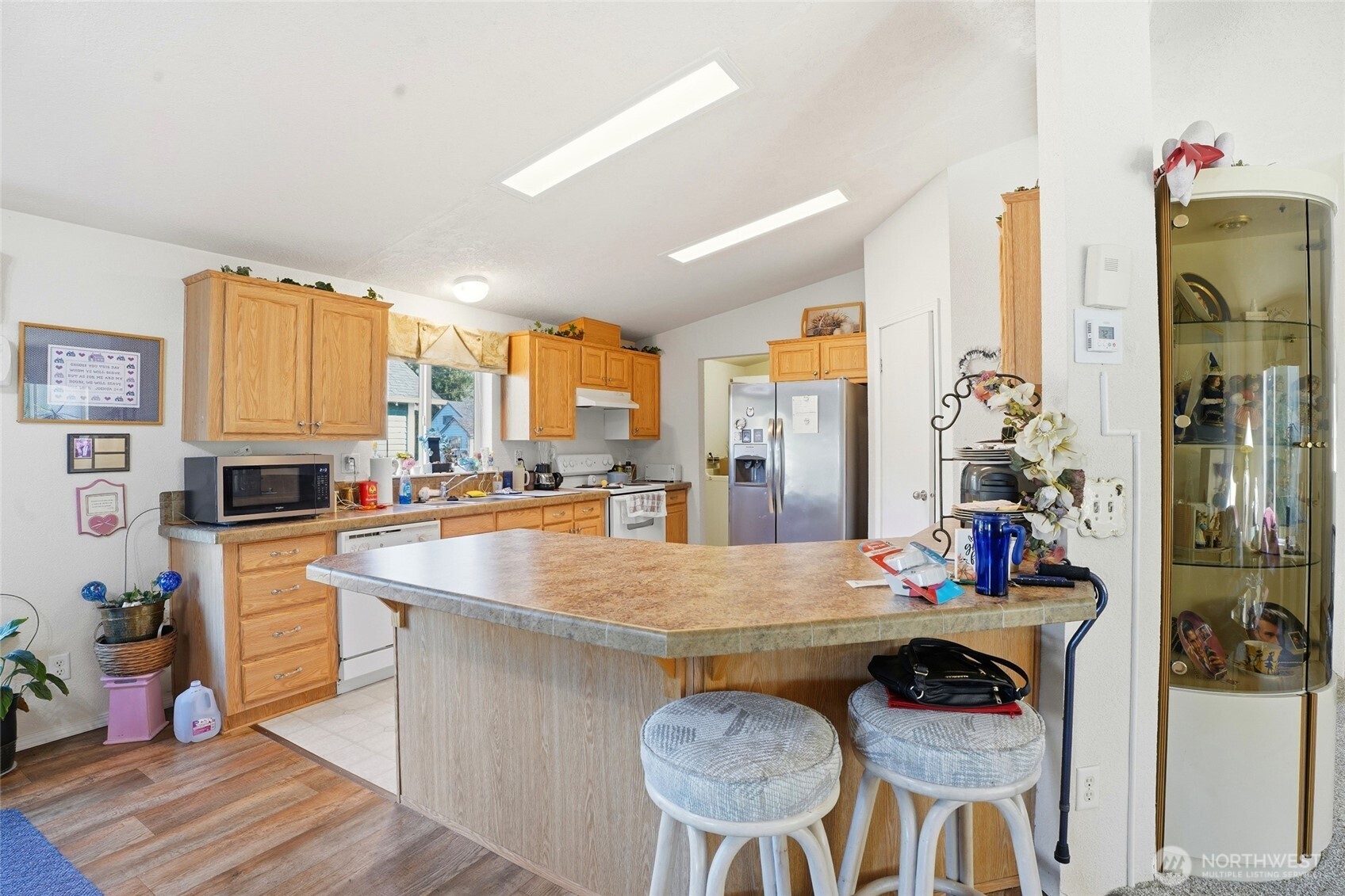 1003 Lord Street Kelso, WA 98626 - Photo 13 of 29 a kitchen with stainless steel appliances granite countertop a stove a refrigerator a oven a sink with island chairs and wooden floor