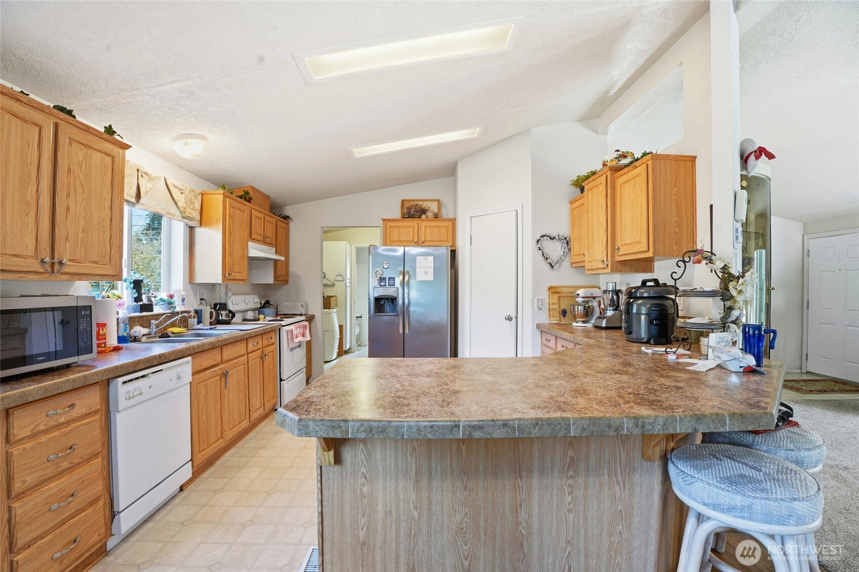 1003 Lord Street Kelso, WA 98626 - Photo 14 of 29 a kitchen with stainless steel appliances granite countertop a sink dishwasher and cabinets with wooden floor