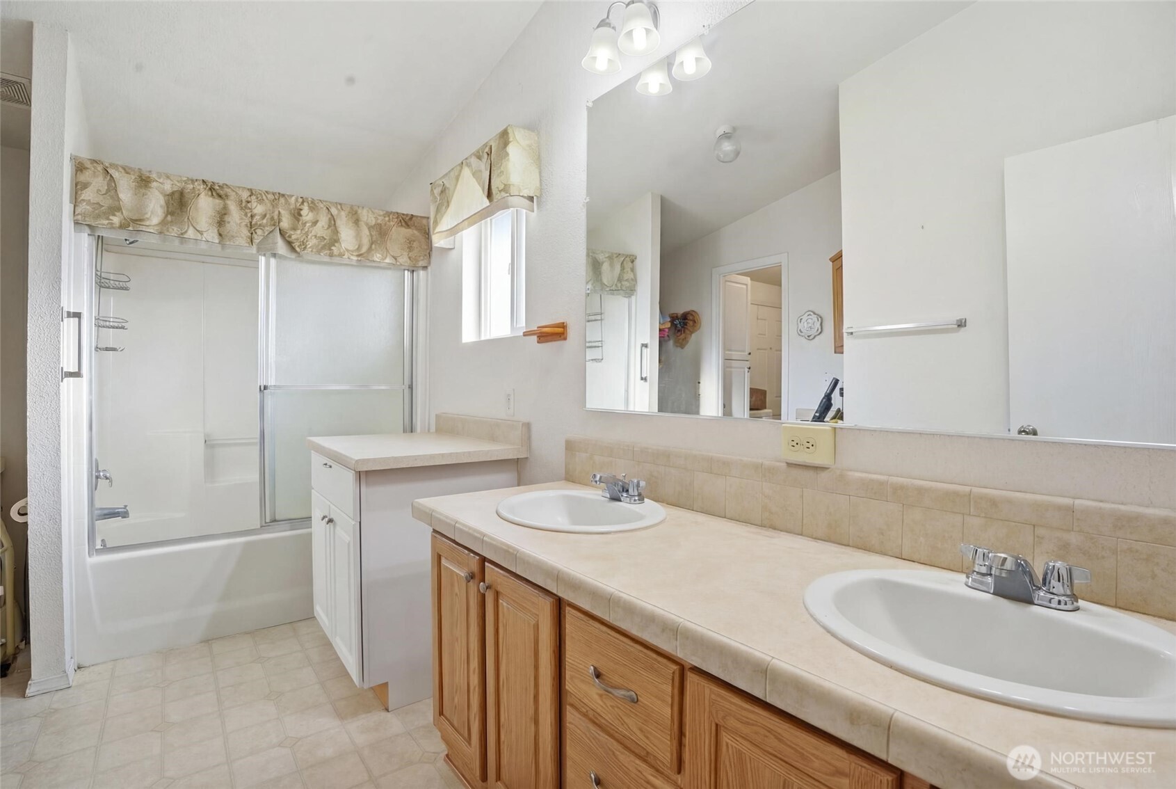 1003 Lord Street Kelso, WA 98626 - Photo 23 of 29 a bathroom with a sink double vanity and a mirror