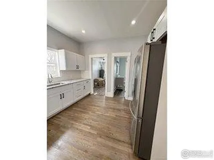 a kitchen with granite countertop a refrigerator and a stove