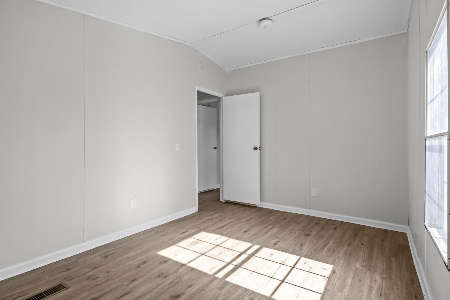 624 Nickletown Road Sugar Tree, TN 38380 - Photo 33 of 45 an empty room with wooden floor and windows