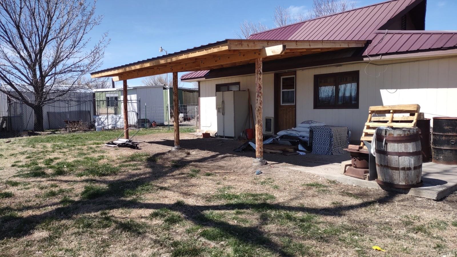 3465 G Road Clifton, CO 81520 - Photo 16 of 18 a view of a chairs and table in backyard
