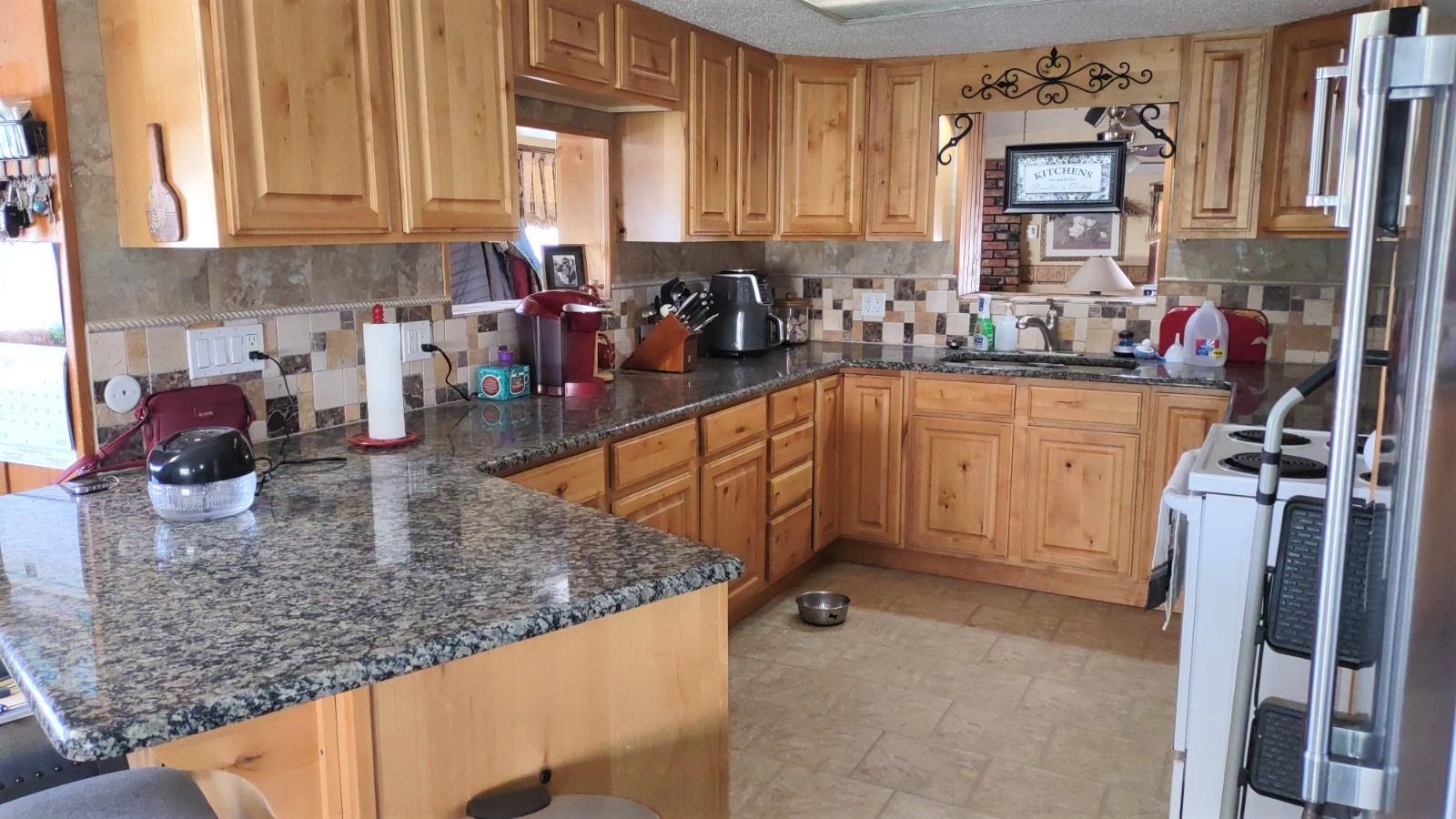 3465 G Road Clifton, CO 81520 - Photo 8 of 18 a kitchen with a sink a stove and cabinets