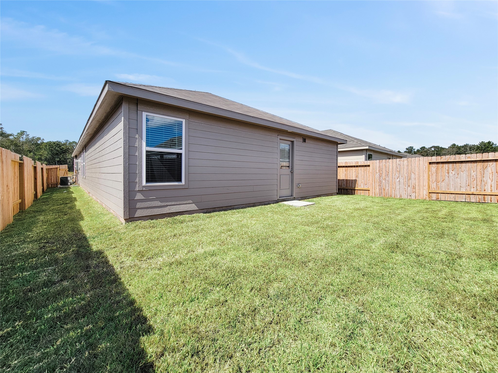 14611 North Ascot Bnd Circle Conroe, TX 77306 - Photo 14 of 16 a backyard of a house with lots of green space