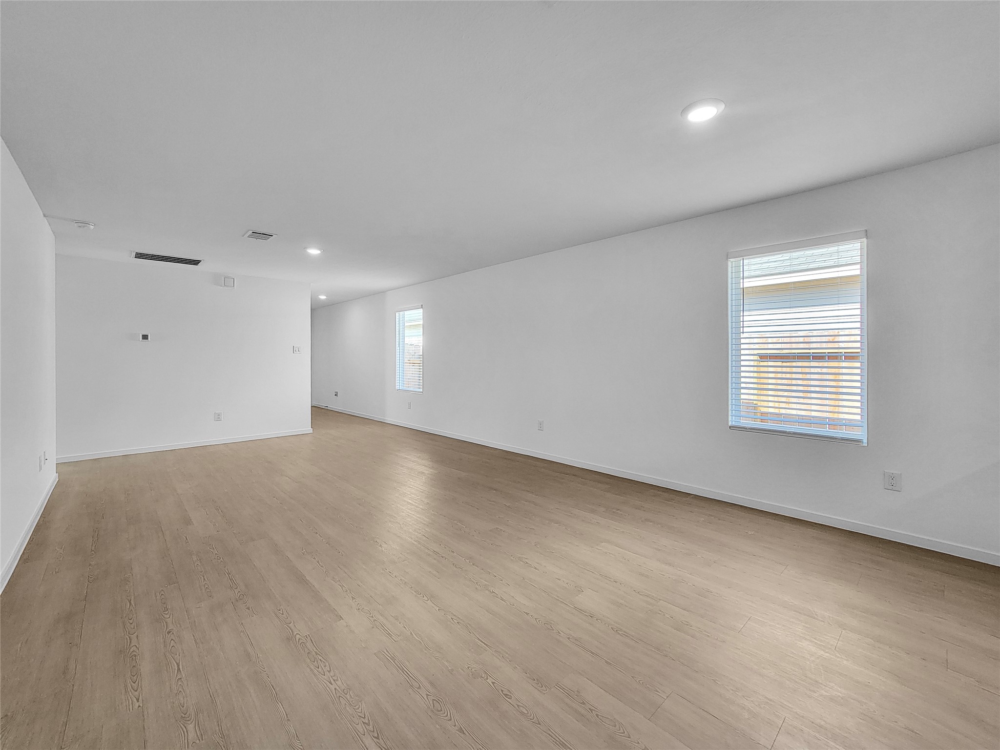 14611 North Ascot Bnd Circle Conroe, TX 77306 - Photo 3 of 16 an empty room with wooden floor and windows