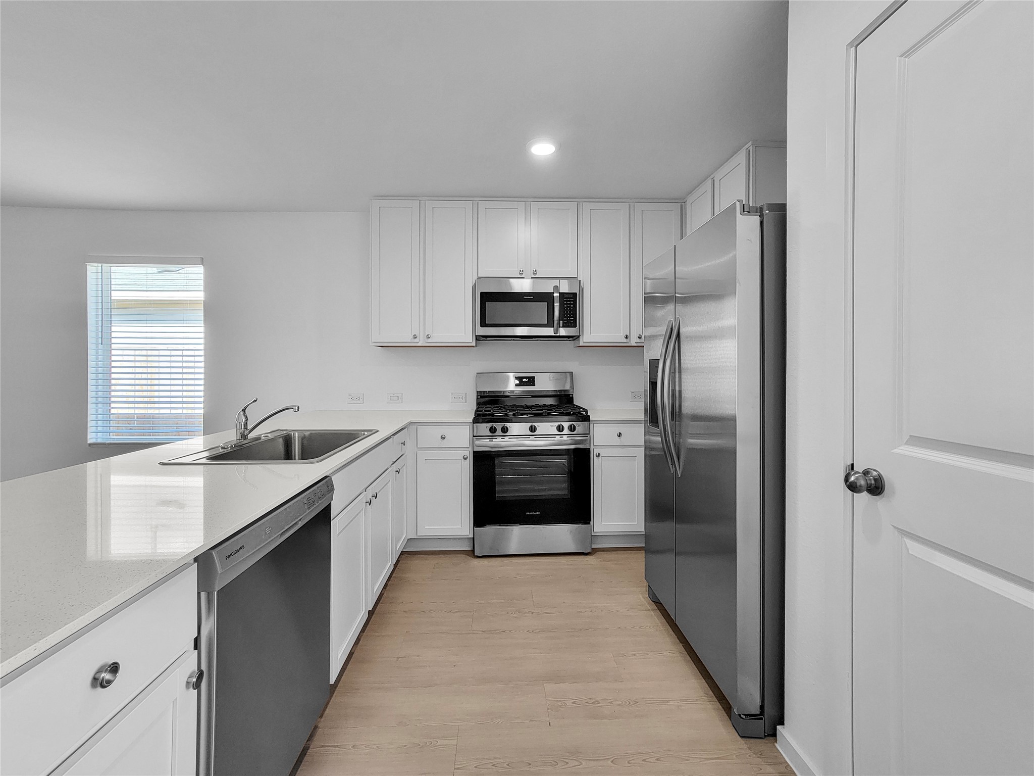 14611 North Ascot Bnd Circle Conroe, TX 77306 - Photo 5 of 16 a kitchen with granite countertop a refrigerator and a stove top oven