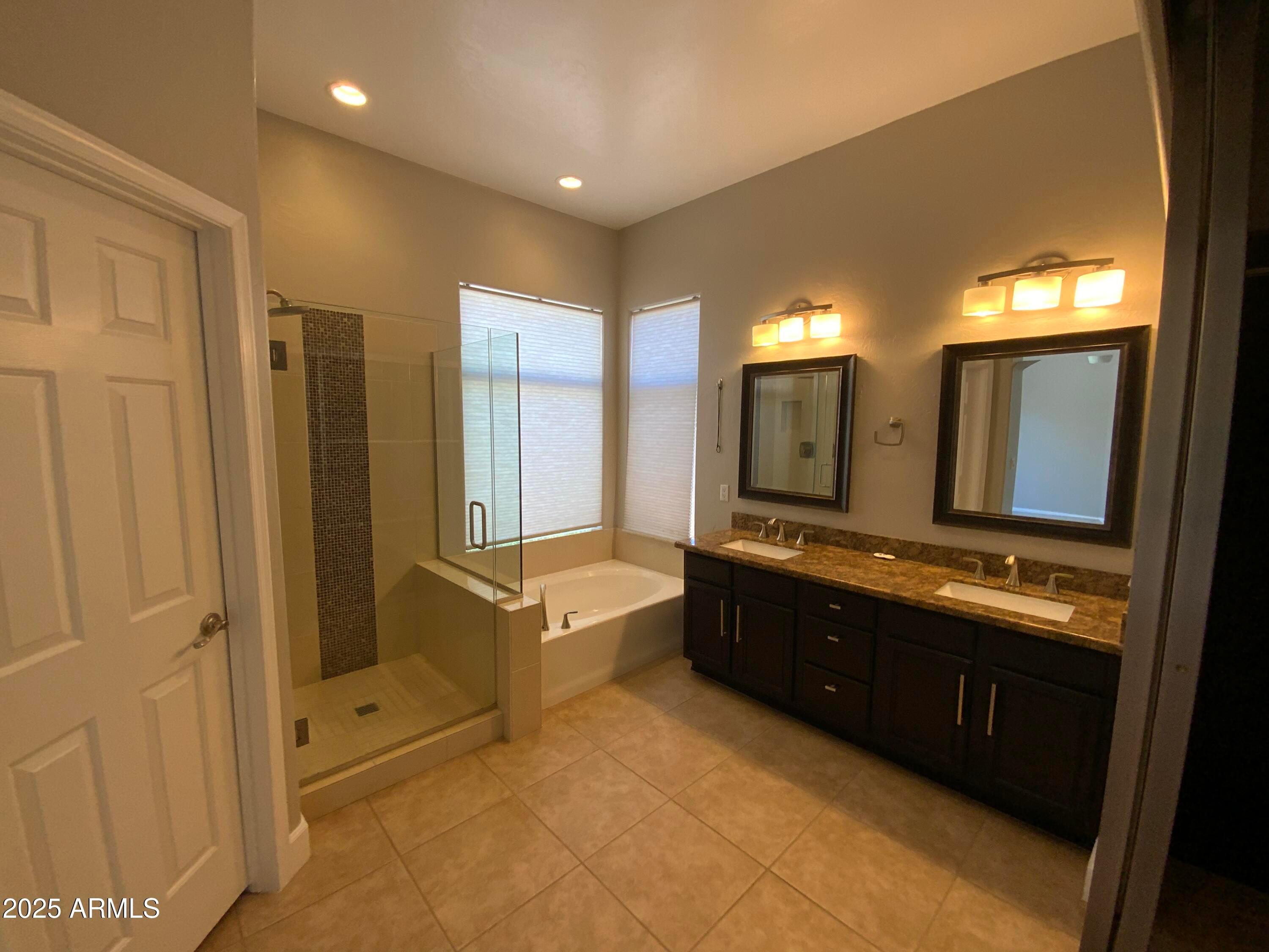 6204 East Phelps Road Scottsdale, AZ 85254 - Photo 15 of 25 a bathroom with a tub sink shower and mirror