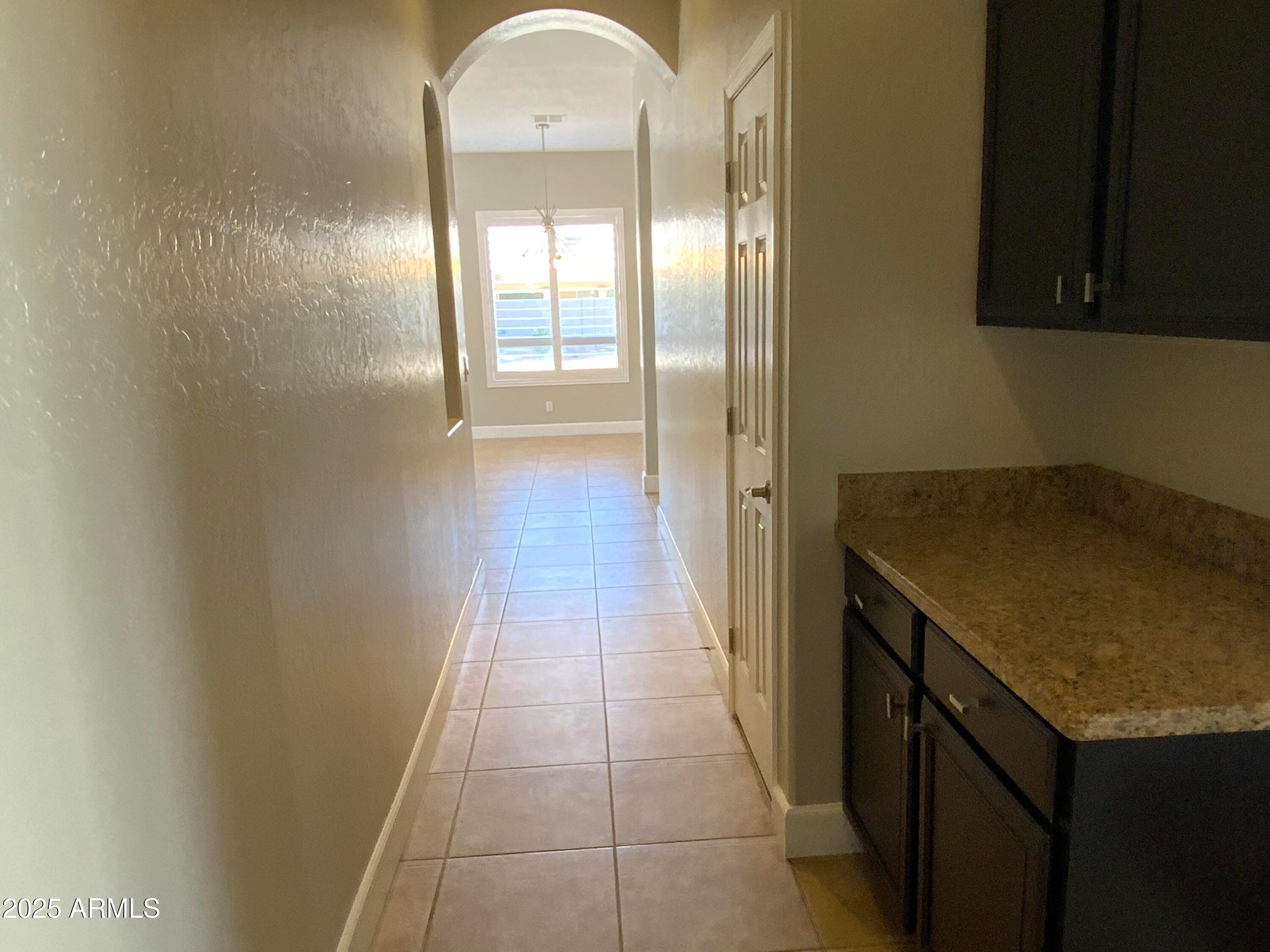 6204 East Phelps Road Scottsdale, AZ 85254 - Photo 17 of 25 a view of a kitchen from the hallway