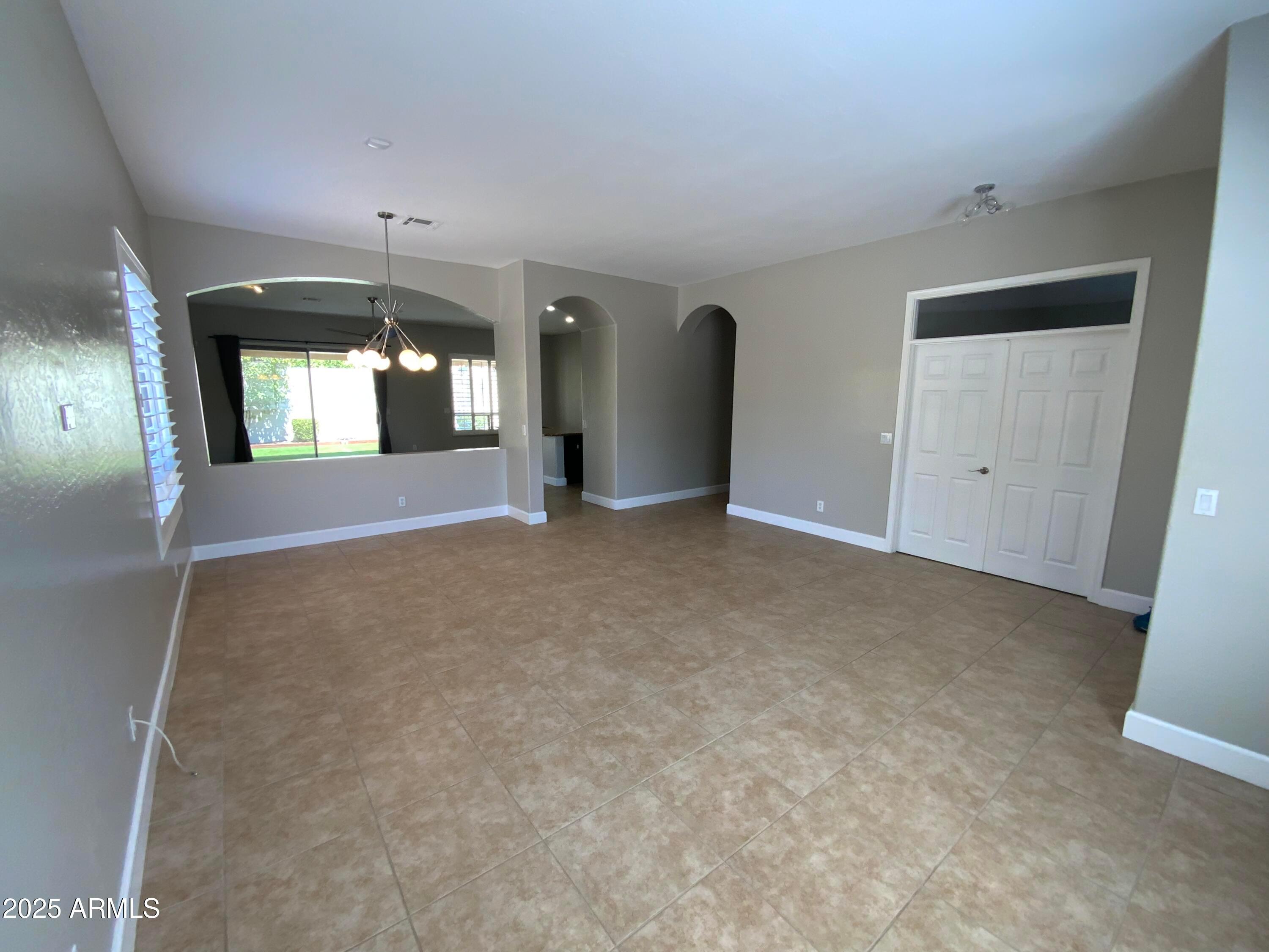 6204 East Phelps Road Scottsdale, AZ 85254 - Photo 9 of 25 an empty room with windows and entrance