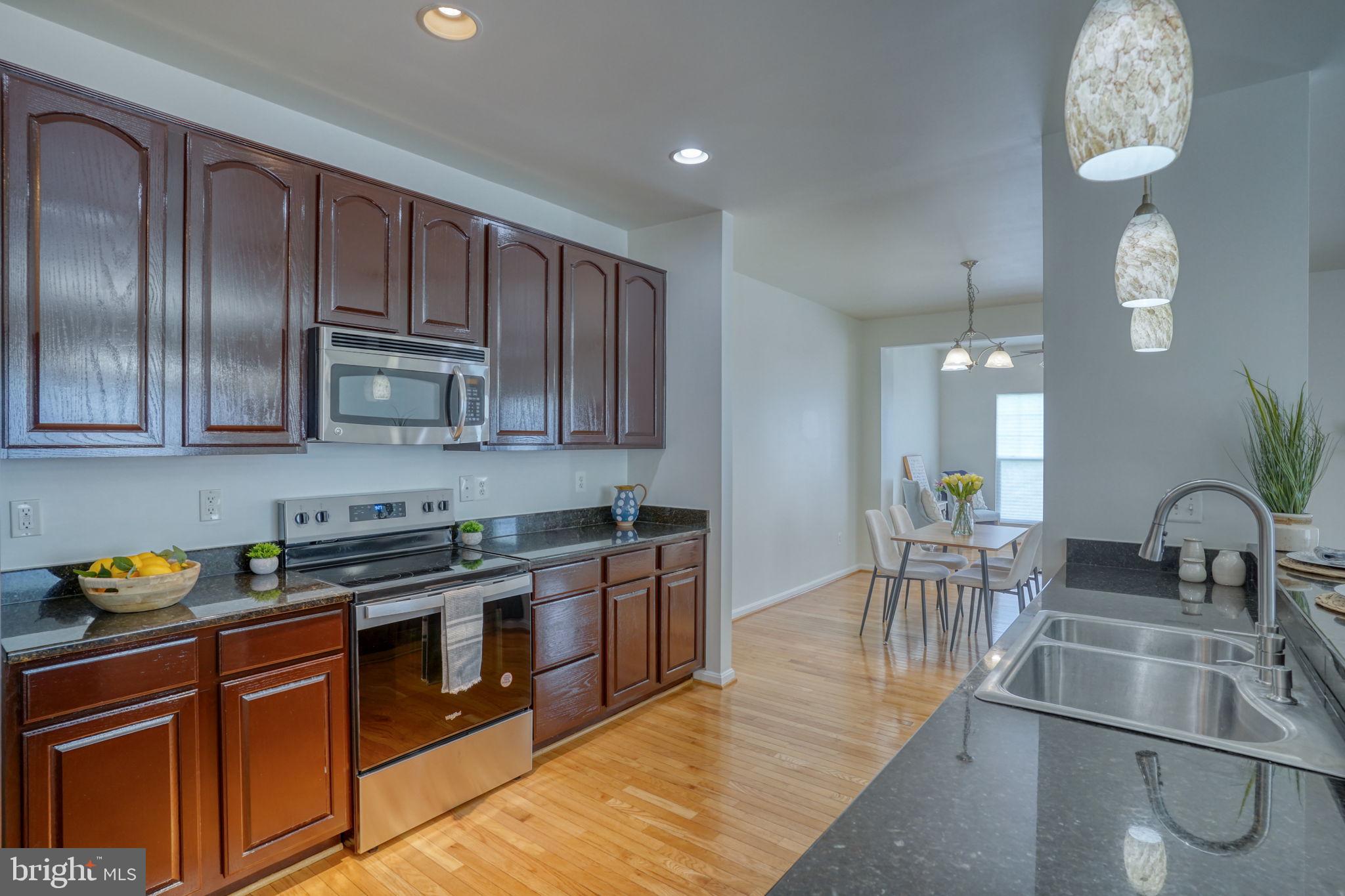 305 Appleby School Road Cambridge, MD 21613 - Photo 17 of 53 a kitchen with stainless steel appliances granite countertop a sink stove and cabinets