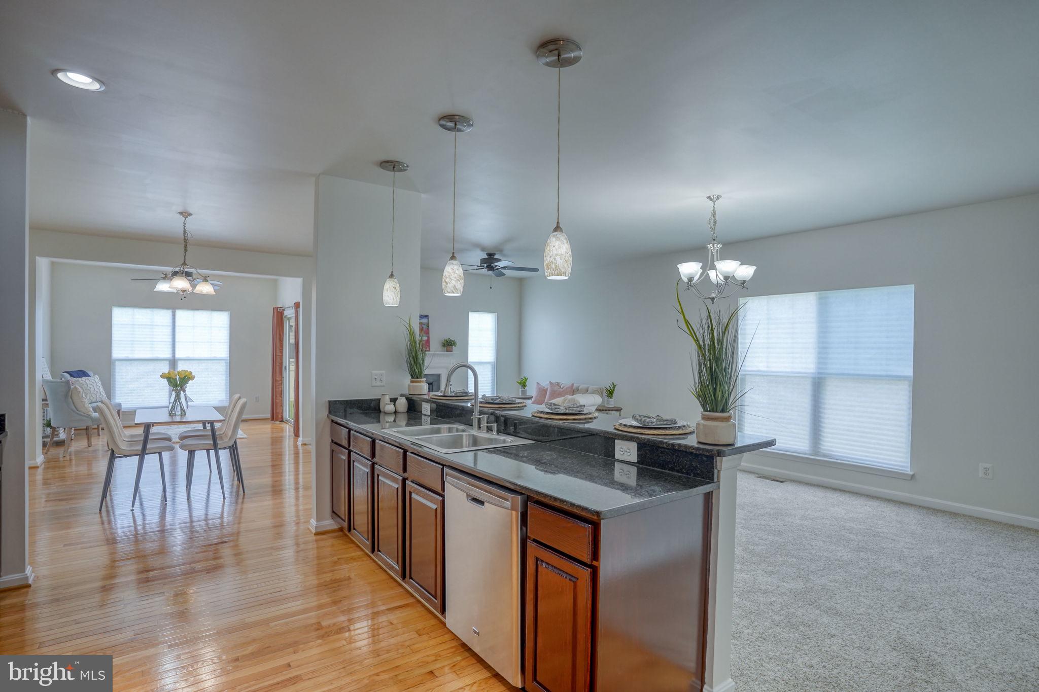 305 Appleby School Road Cambridge, MD 21613 - Photo 18 of 53 a kitchen with stainless steel appliances granite countertop a sink a stove and a wooden floors