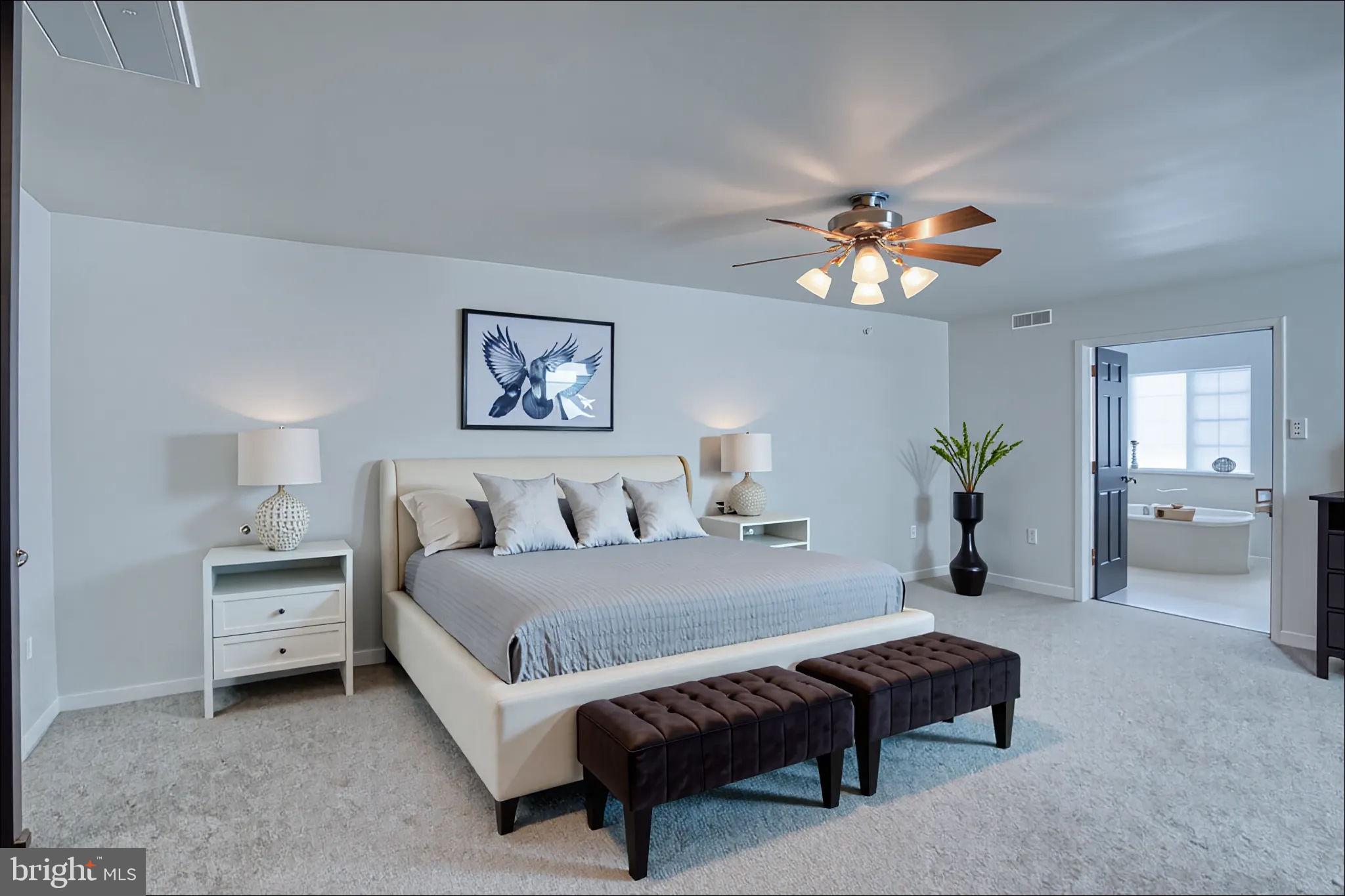305 Appleby School Road Cambridge, MD 21613 - Photo 28 of 53 a bedroom with a bed furniture and a chandelier