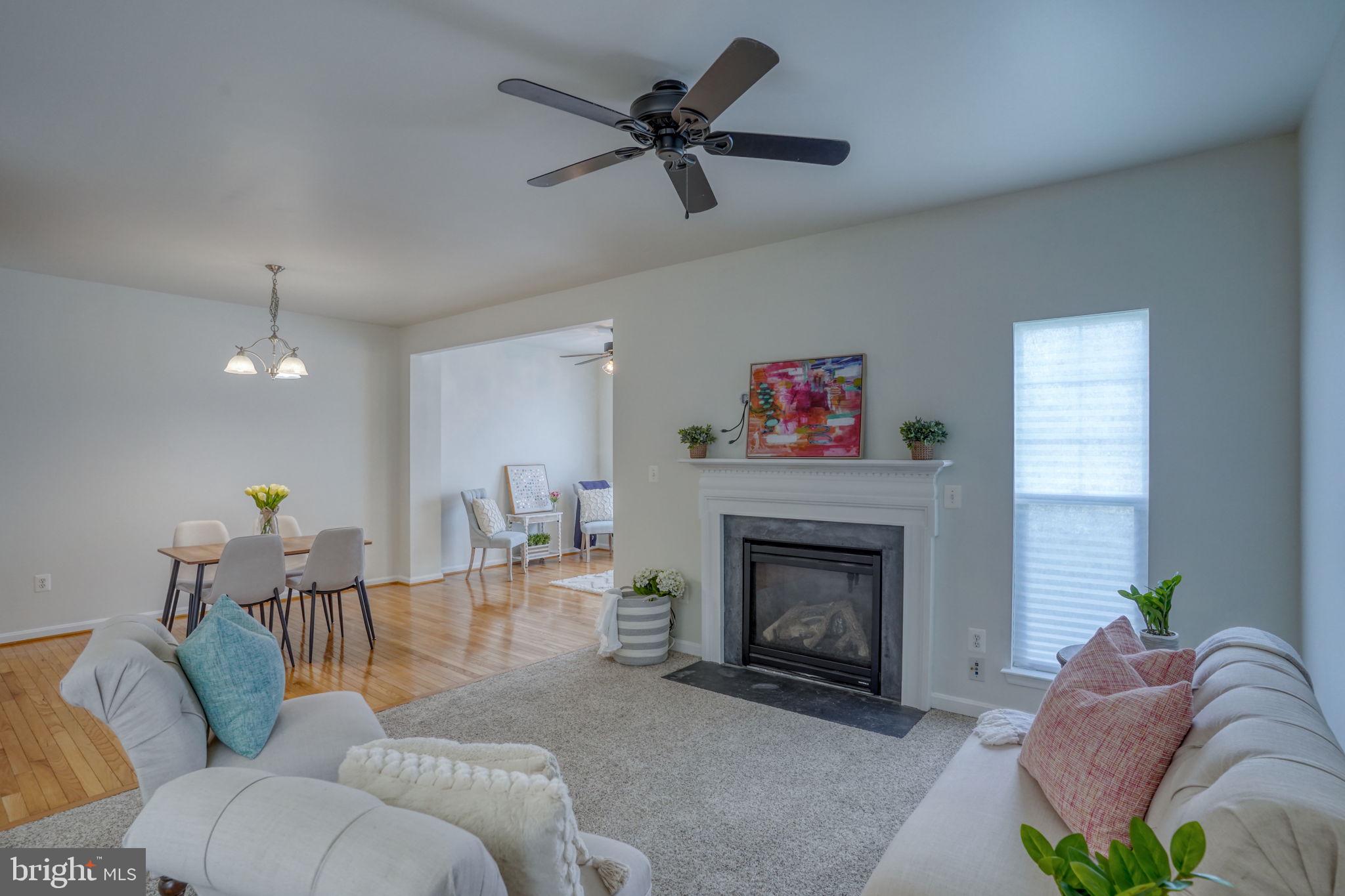 305 Appleby School Road Cambridge, MD 21613 - Photo 9 of 53 a living room with furniture a fireplace and a ceiling fan