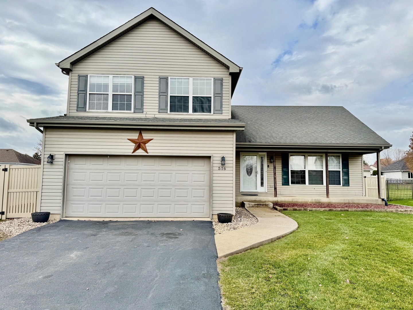 a front view of a house with a yard and garage