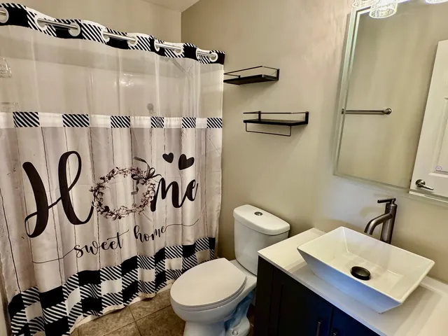 a white toilet sitting next to a bathroom sink