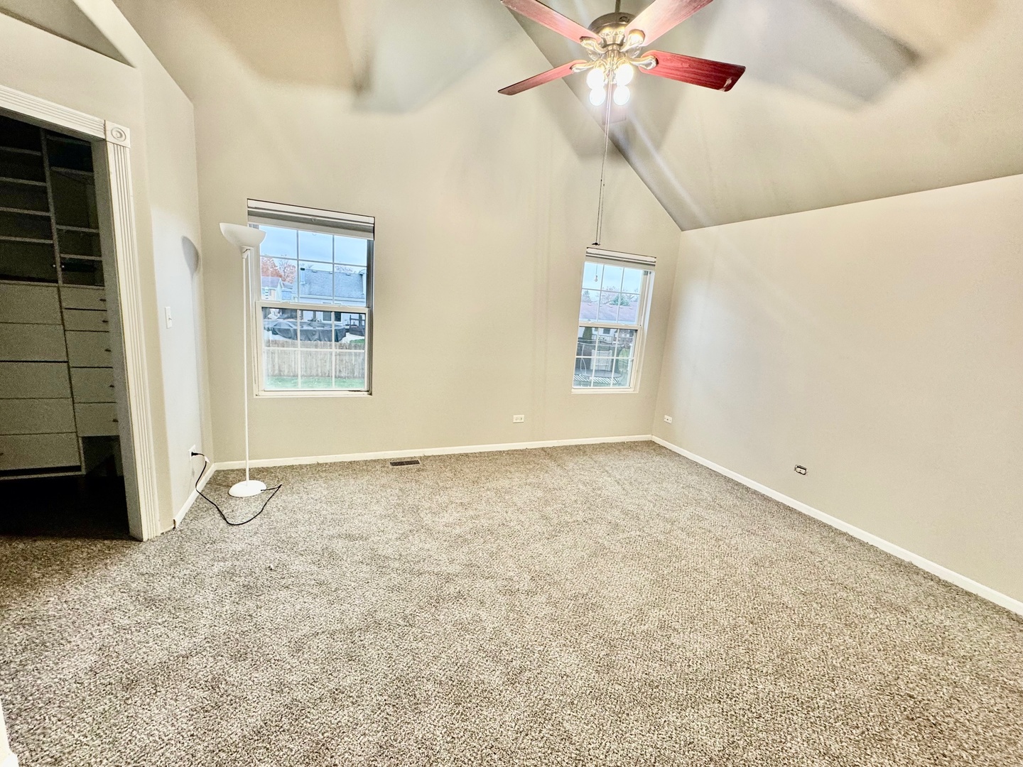 516 Chestnut Lane Peotone, IL 60468 - Photo 14 of 27 an empty room with windows and fan