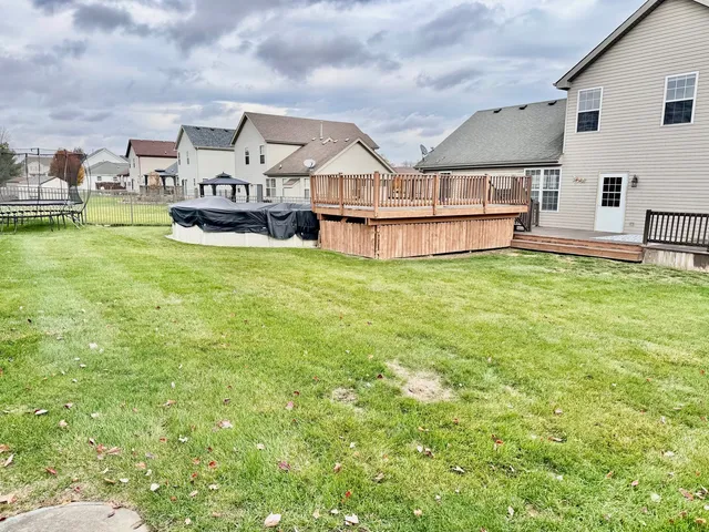 a view of a house with a big yard and large trees