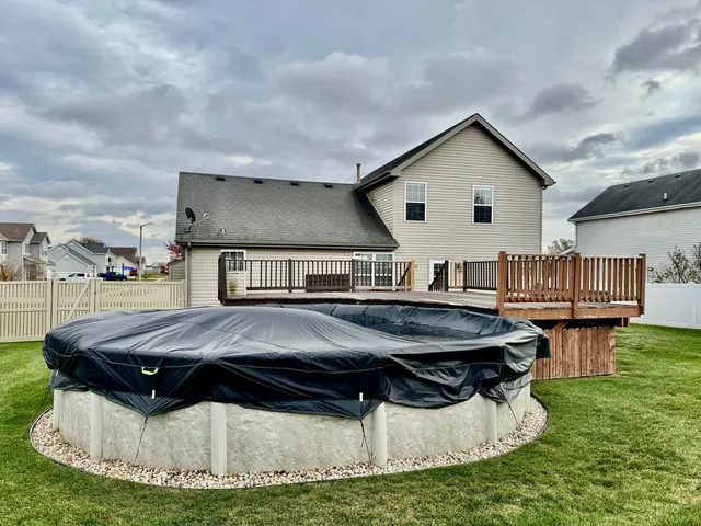 a view of a house with pool and chairs