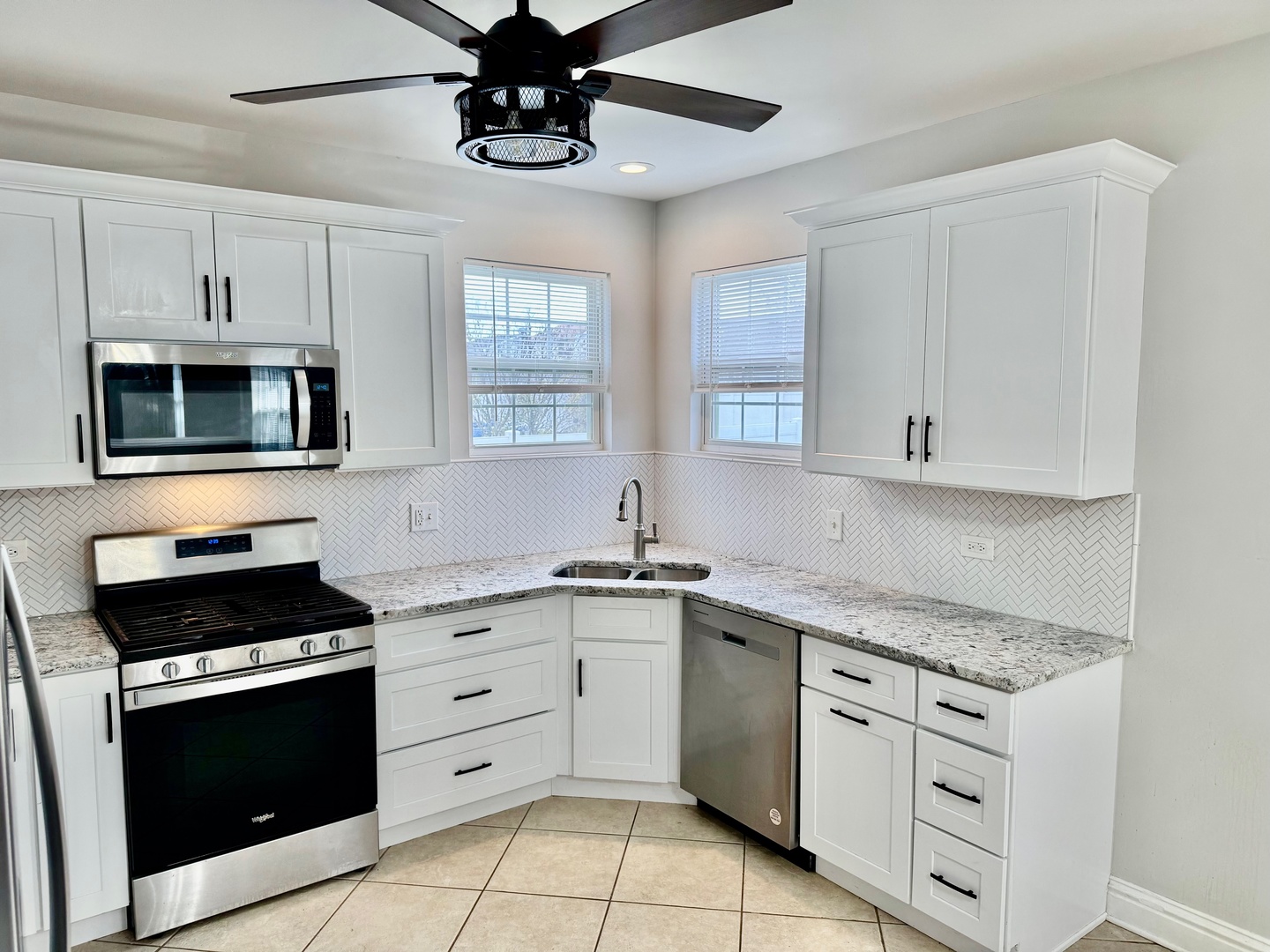 516 Chestnut Lane Peotone, IL 60468 - Photo 10 of 27 a kitchen with white cabinets stainless steel appliances and a window