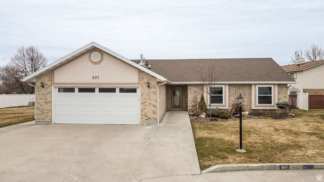 897 North 250 West Logan, UT 84321 - Photo 1 of 1 Ranch-style home with brick siding, a garage, concrete driveway, and a shingled roof
