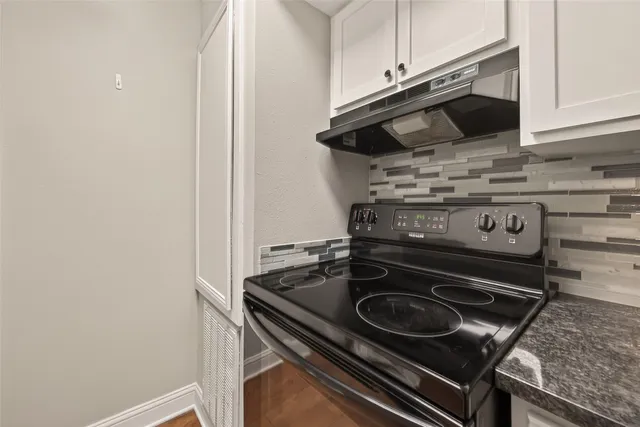 a stove top oven sitting inside of a kitchen