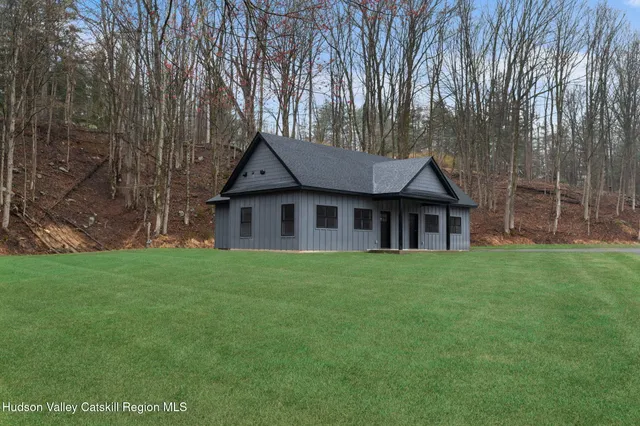 a house with huge green field in front of it