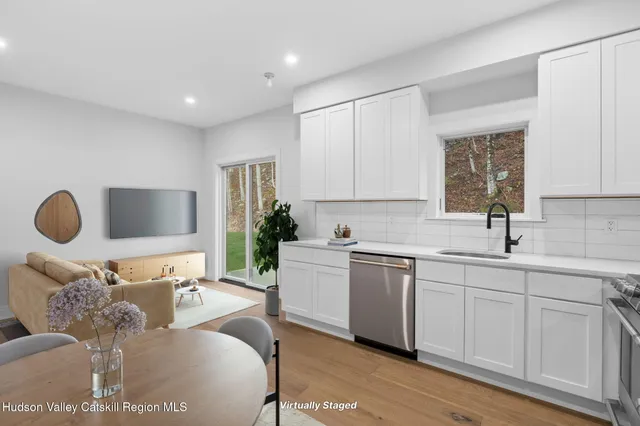 a living room with furniture a window and a sink
