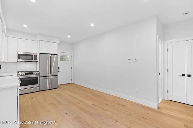 a kitchen with stainless steel appliances a refrigerator and a stove top oven