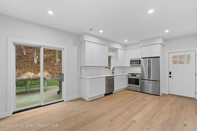 a kitchen with a refrigerator and a stove top oven