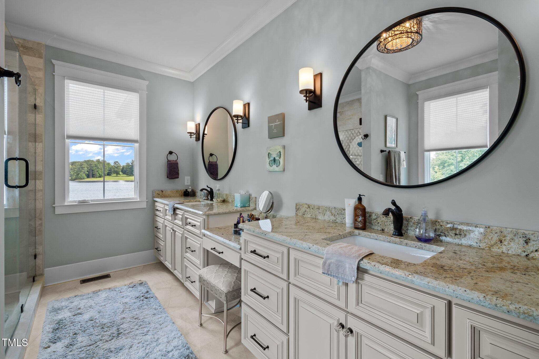 976 Estate Road Semora, NC 27343 - Photo 34 of 74 a bathroom with a double vanity sink and a mirror