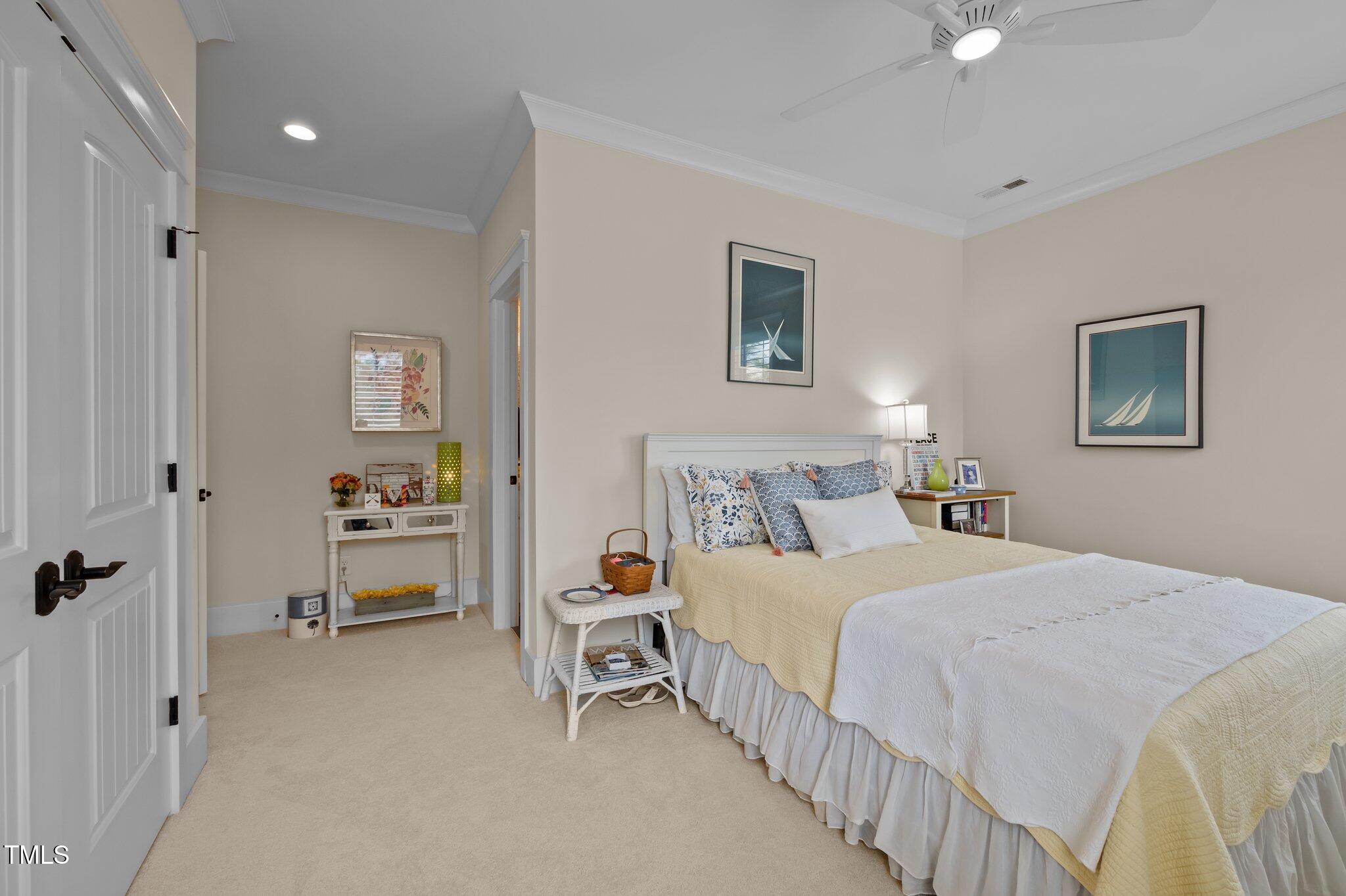 976 Estate Road Semora, NC 27343 - Photo 42 of 74 a bedroom with a bed and a chandelier