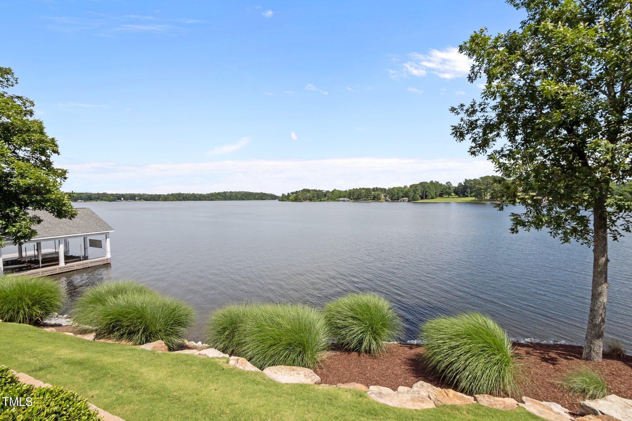 976 Estate Road Semora, NC 27343 - Photo 56 of 74 a view of a lake with a house in the background