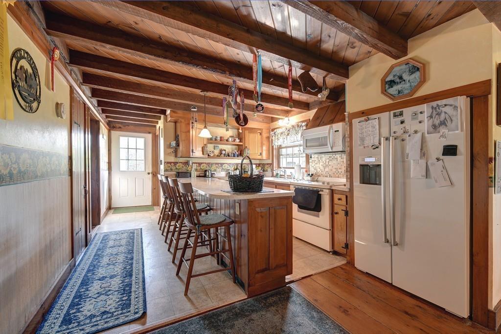 440 Huntington Road Worthington, MA 01098 - Photo 14 of 34 a kitchen with refrigerator and chairs