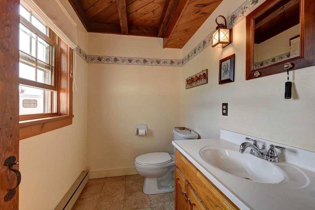 440 Huntington Road Worthington, MA 01098 - Photo 16 of 34 a bathroom with a granite countertop sink a toilet and a mirror