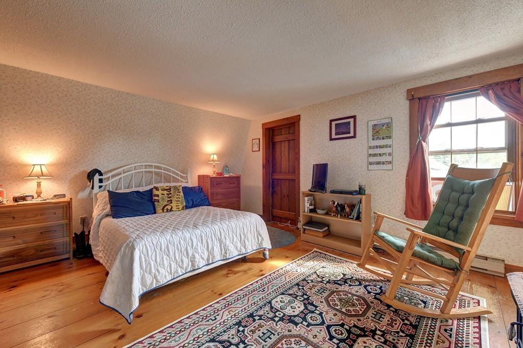 440 Huntington Road Worthington, MA 01098 - Photo 19 of 34 a bedroom with a bed and wooden floor