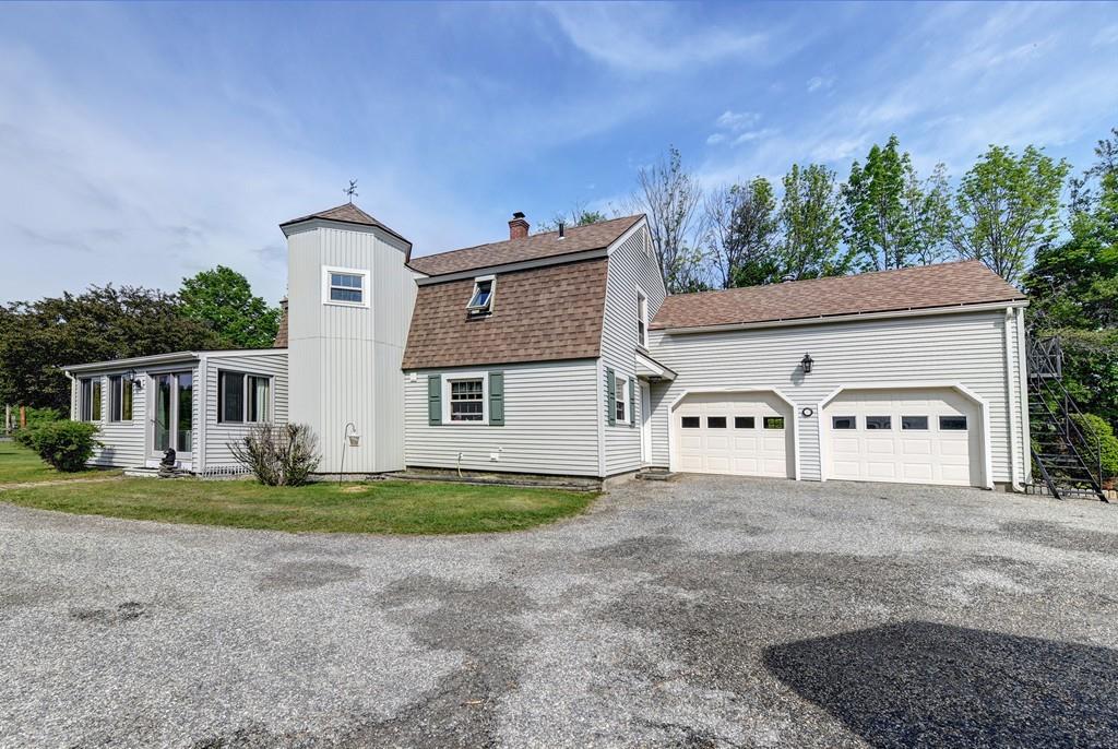440 Huntington Road Worthington, MA 01098 - Photo 2 of 34 a front view of a house with a yard and garage