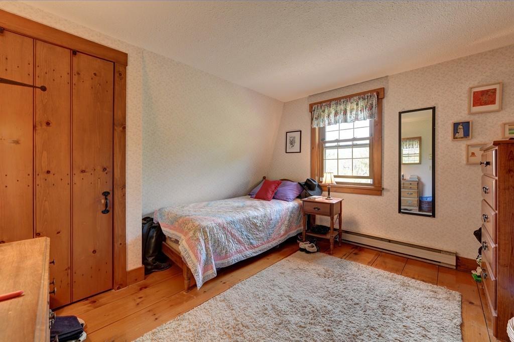 440 Huntington Road Worthington, MA 01098 - Photo 22 of 34 a bedroom with a bed and wooden floor