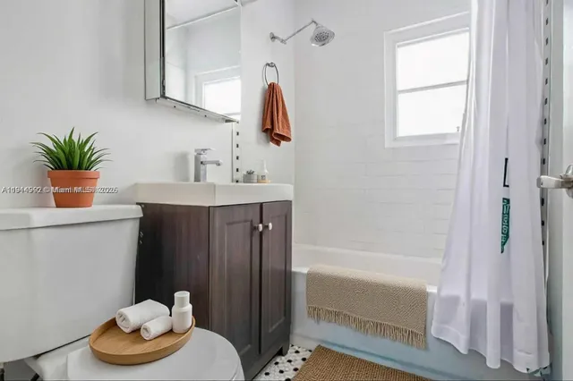 a bathroom with a sink a toilet and bathtub
