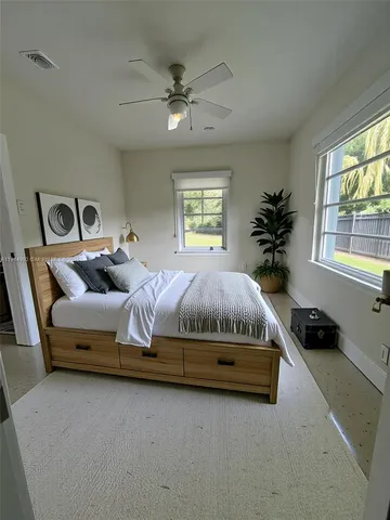 a bedroom with a bed and window