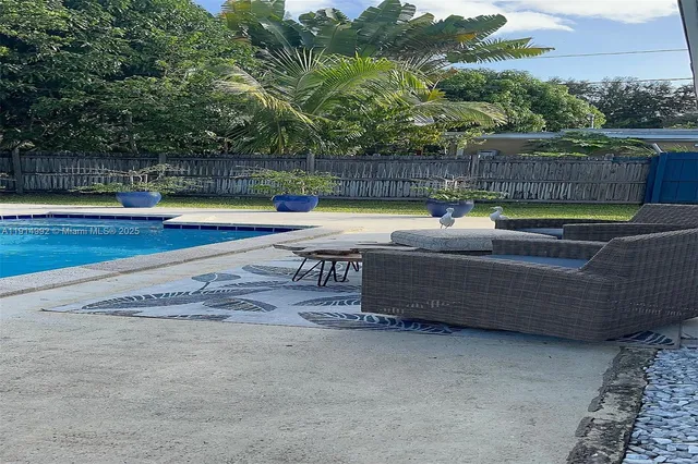 a view of a swimming pool with a yard