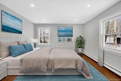 a bedroom with a large bed and a painting on the wall