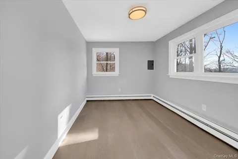 a view of a room with window and wooden floor
